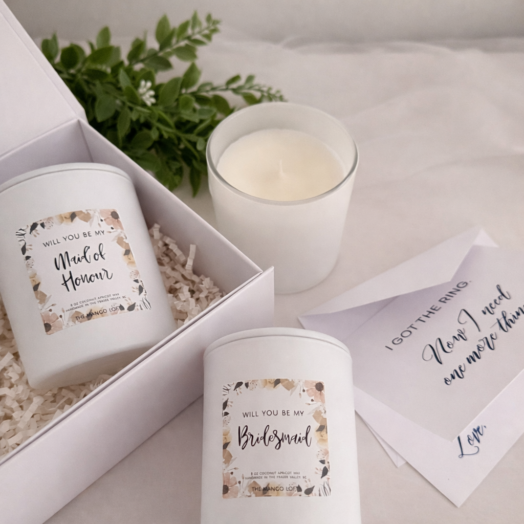 white candle and card on wood board and neutral background